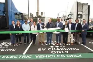 A fleet of zero-emission trucks at 4 Gen Logistics' Port of Long Beach facility, with newly installed Hyper-Fast chargers in the background. The chargers are part of a collaboration with Electrify America to support sustainable freight transportation.